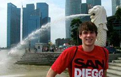 a student poses in front of a fountain in Singapore