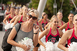 cheer squad marching with parent