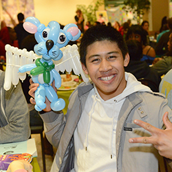 Student with balloon animal at Midnight Study Break