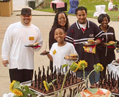 a family enjoys the food at the picnic