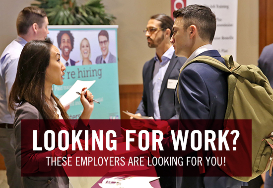 Looking for work? These employers are looking for you! photo of student talking to employer at career fair