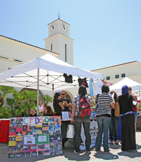 students attend a club fair on campus