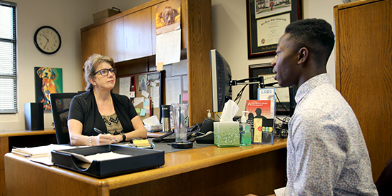 student sitting in student ombudsman office speaking with mediator